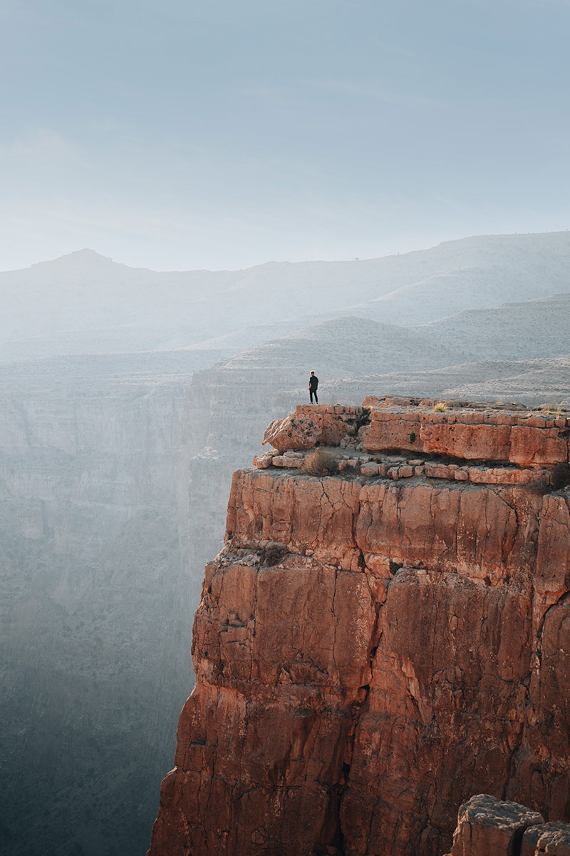 standing on the edge of the canyon