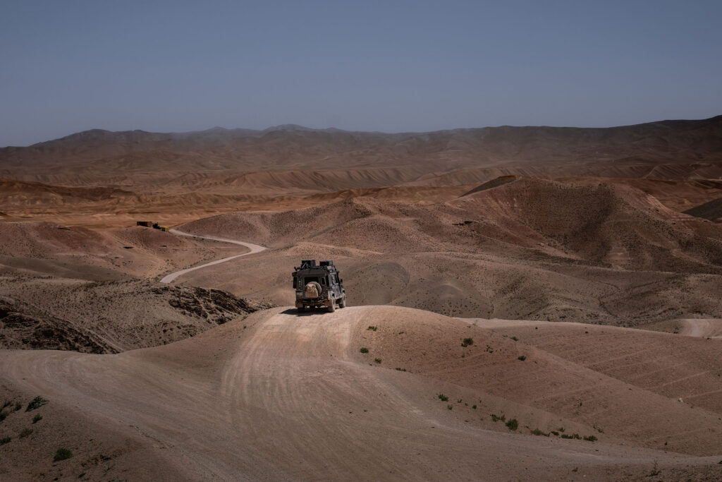 hilly landscapes, a dirt road and a landrover defender