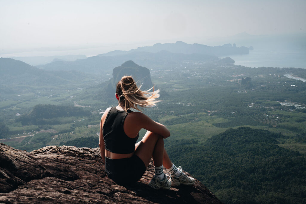sitting at the edge of the cliff of dragon crest trail