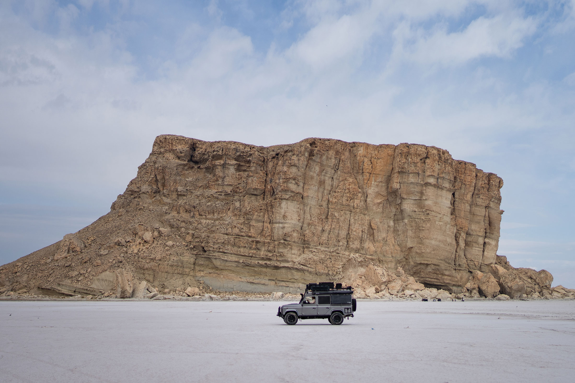 landrover defender driving over the salt lake